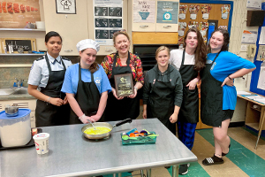 2022 CTE Teacher of the Year named. Pictured with students.